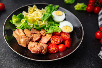 chicken liver salad tomato, green leaf lettuce, boiled egg, farfalle pasta pasta salad ready to eat healthy meal food snack on the table copy space food background rustic top view