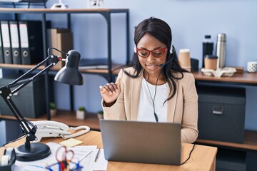 Young african american woman call center agent having video call at office
