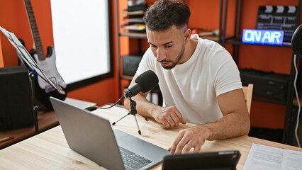 Young arab man musical reporter speaking on radio show radio studio