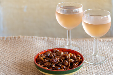 French cold rose dry wine from Provence in glass served for lunch in restaurant with sweet pindas nuts, Aigues-Mortes, Gard, France