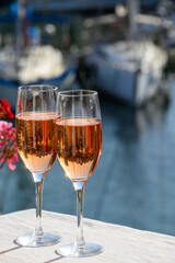 Summer party, drinking of French brut rose champagne sparkling wine in glasses in yacht harbour of Port Grimaud near Saint-Tropez, French Riviera vacation, France