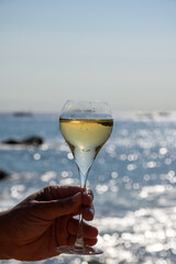 Summer time in Provence, two glasses of cold champagne cremant sparkling wine on sandy beach near Saint-Tropez in sunny day, Var department, France