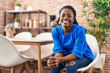 African american woman smiling confident sitting on chair at home