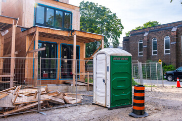 on site toilet facility outside the fencing at a residential construction site shot in summer in...