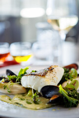 Cod fillet with cauliflower cream, asparagus, clam-wine sauce and mussles. Delicious seafood fish closeup served on a table for lunch in modern cuisine gourmet restaurant - 635143938