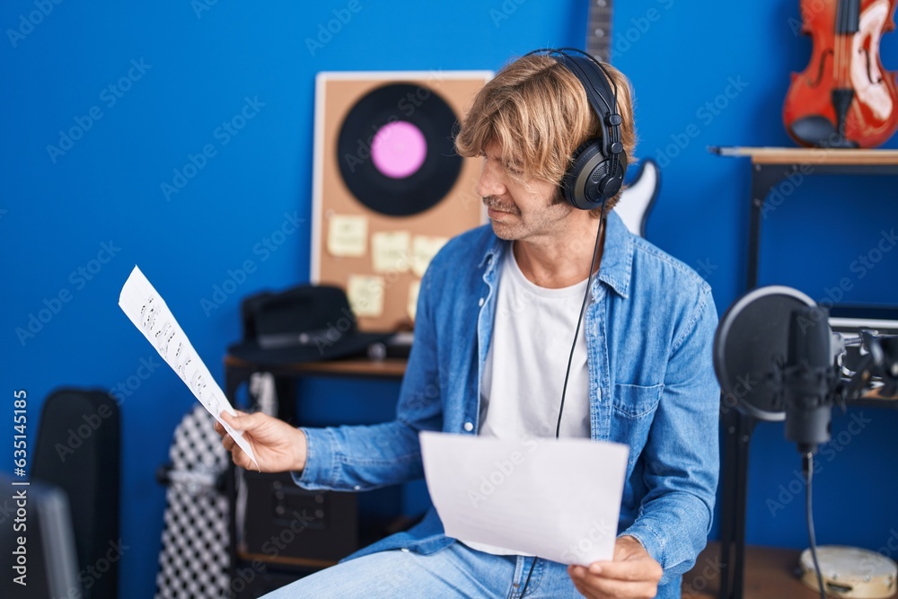 Sticker Young man artist reading song at music studio