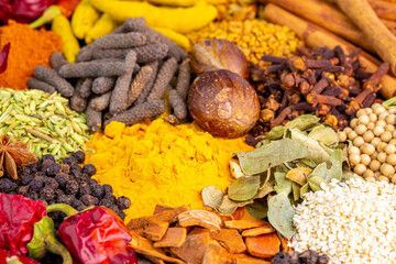 Various spices, peppers and herbs close-up top view. Eastern spice market. A set of peppers and spices for cooking.