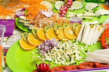 Assorted sliced vegetables and fruits. Figured cutting of vegetables and fruits. Food vegan concept.