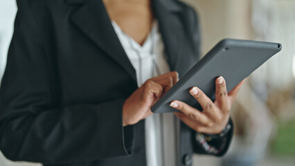 African american woman architect using touchpad at construction site