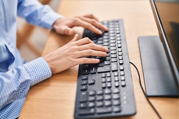 Young caucasian man using computer keyboard at office