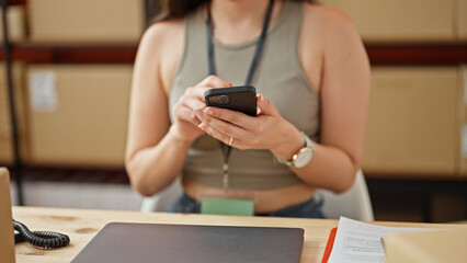 Fototapeta premium Young beautiful hispanic woman ecommerce business worker using smartphone at office