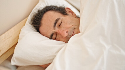 Fototapeta na wymiar Middle age man lying on bed sleeping at bedroom