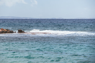 Beautiful landscape of wavy sea, waves hitting the rocks in the sea