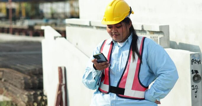Portrait African american woman. Plus size female factory worker wearing safety hard hat helmet working at heavy Prefabricated concrete walls manufacturing factory