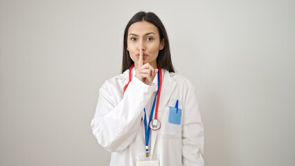 Young beautiful hispanic woman doctor asking for silent over isolated white background