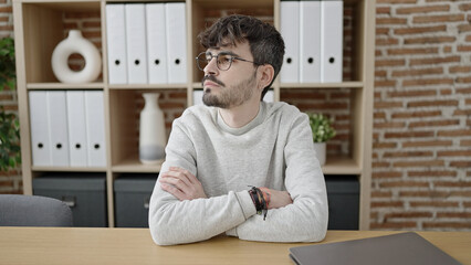 Young hispanic man business worker smiling confident standing at office