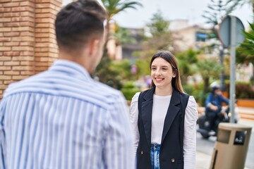 Man and woman couple smiling confident standing together at street