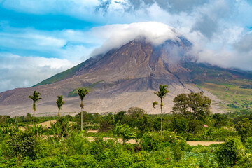 The summit of Mount Sinabung in North Sumatra is veiled in a shroud of white clouds.