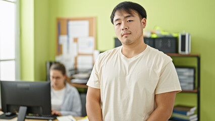 Fototapeta premium Man and woman business workers standing with relaxed expresison working at office