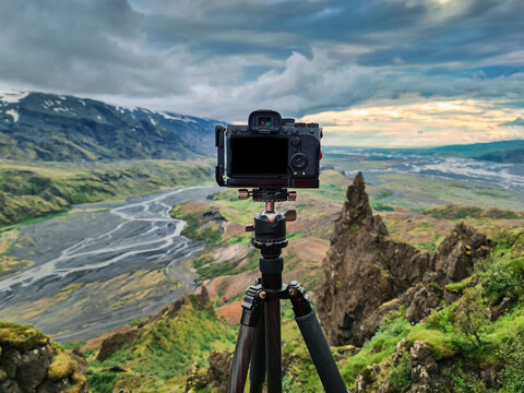 Mirrorless camera standing on tripod and taking photos at viewpoint of thorsmork valley