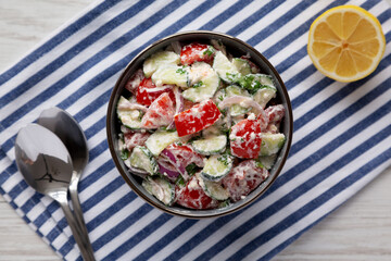Homemade Tomato Cucumber Feta Salad in a Bowl, top view. Flat lay, overhead, from above.