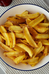 Homemade French Fries with Ketchup on a Plate, top view. Flat lay, overhead, from above.