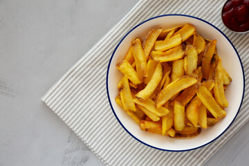 Homemade French Fries on a Plate, top view. Flat lay, overhead, from above. Copy space.
