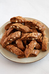 Homemade Italian Cantuccini with Almond and Coffee on a Plate on a gray surface, side view. Crispy Almond and Coffee Cookies.