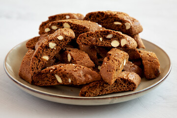 Homemade Italian Cantuccini with Almond and Coffee on a Plate on a gray surface, side view. Crispy Almond and Coffee Cookies.