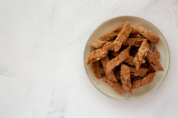 Homemade Italian Cantuccini with Almond and Coffee on a Plate on a gray surface, side view. Crispy Almond and Coffee Cookies.