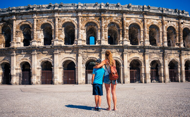 Fototapeta na wymiar mother and son visiting Nimes city Arena in France