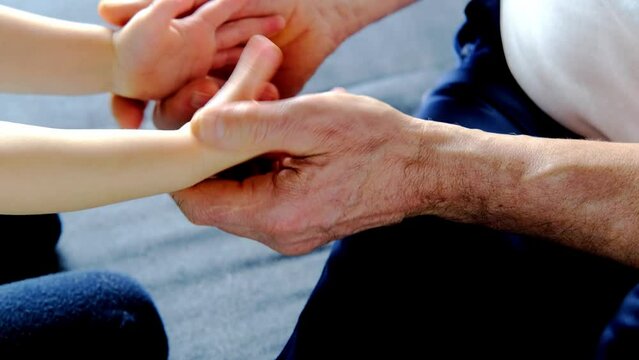 adult male hands holding kid hands, Family Help Care Concept, small hands in fathers hand, touching moment, touch of child and old man, grandfather, parents and child, adopted children, adoption