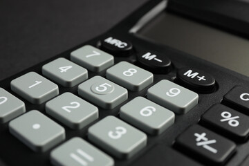 Obraz premium Calculator on black background, closeup. Office stationery