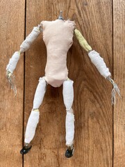 Close up of animation armature of single human figure headless, construct steel twisted wire for body torso arms legs metal bolts clay bones between stuffed cloth joints built for stop motion video