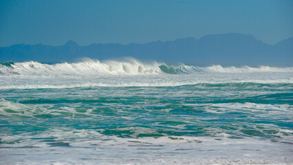  powerful cross ocean wave breaking during the day on the beach