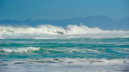  powerful cross ocean wave breaking during the day on the beach