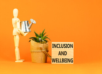 Inclusion and wellbeing symbol. Concept words Inclusion and wellbeing on wooden block. Beautiful...