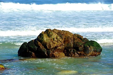  powerful cross ocean wave breaking during the day on the beach