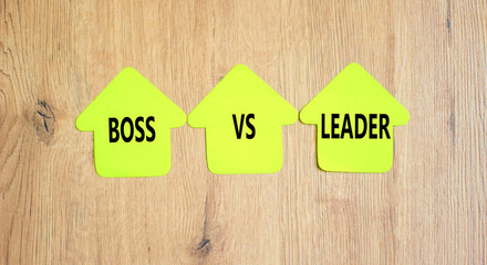 Boss vs leader symbol. Concept words Boss vs versus leader on beautiful yellow paper house. Beautiful wooden background. Business motivational boss vs leader concept. Copy space.