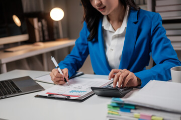 Cheerful young businesswoman sitting at her workplace