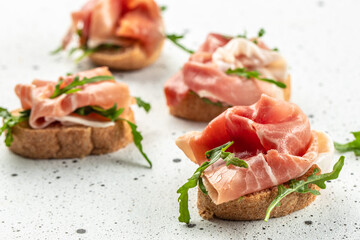 Delicious appetiser Italian prosciutto and Spanish Iberian ham snack. Food recipe background. Close up - obrazy, fototapety, plakaty