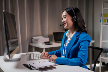 Young friendly operator woman agent with headsets working in a call centre.