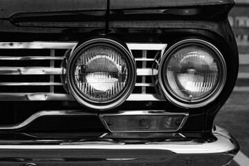 Classic car headlights close-up. Headlights of black vintage car