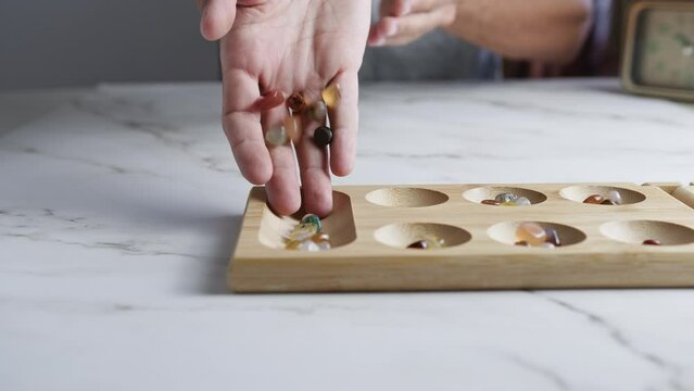 Placing seed to mancala traditional game