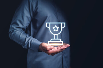 technology, business, trophy, strategy, target, award, online, information, win, successful. palm of hands hold a trophy symbolic icon. it means business of target, via strategy or manage to get it.