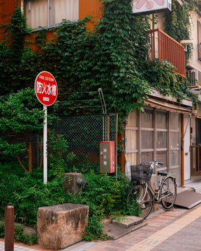 bicycle in front of a building next to a stop sign