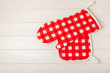 Fototapeta premium Wooden kitchen utensils, cutting board, potholder and glove on the table, top view. Kitchen Mitten and protective oven mitts on the table. Kitchenware. Kitchen accessories.Close-up.top view.