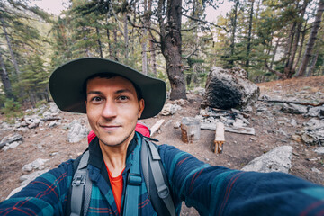 Happy man traveler naturalist against the backdrop of a Lycian way camping and picnic spot in the woods