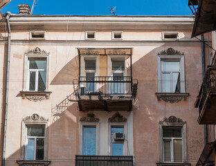 Fototapeta na wymiar Windows and balconies are part of the architecture of old Odessa. They are incredible and authentic.