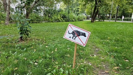 Prohibited to let an animal pets defecating shit in the garden area at public park. Sign and symbol for animal object photo, close-up